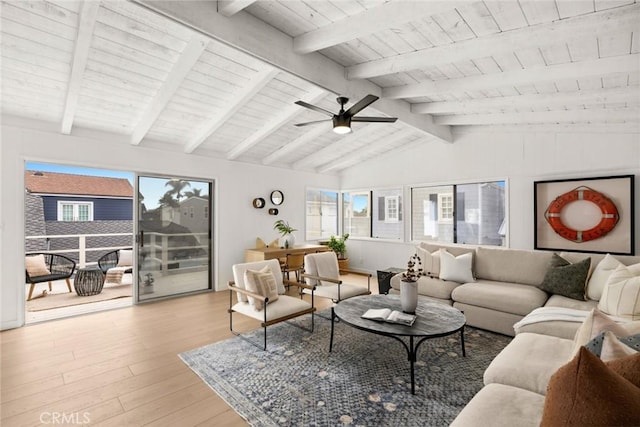 living room with light wood-style floors, a wealth of natural light, vaulted ceiling with beams, and wooden ceiling