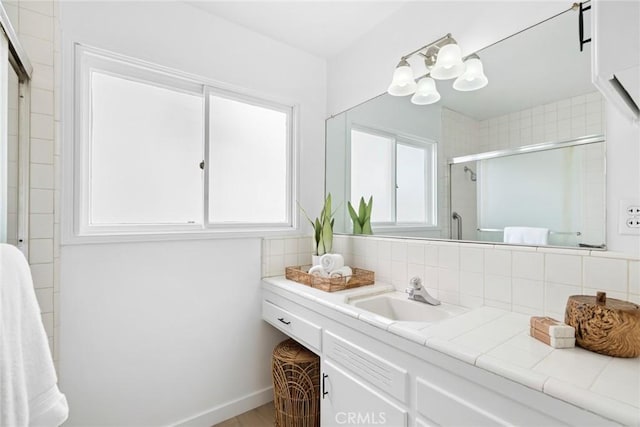 bathroom featuring a shower stall, wood finished floors, decorative backsplash, vanity, and an inviting chandelier