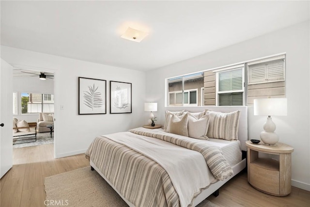 bedroom with light wood-style flooring and baseboards