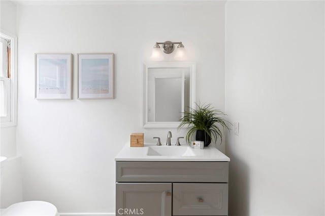 bathroom featuring vanity and toilet