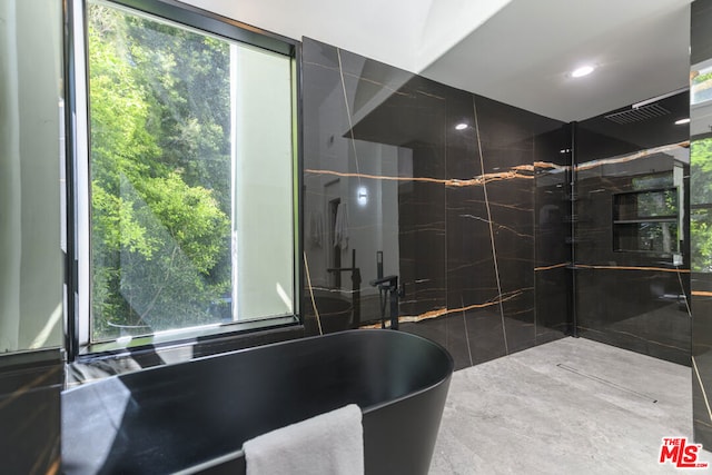 bathroom with a tub to relax in