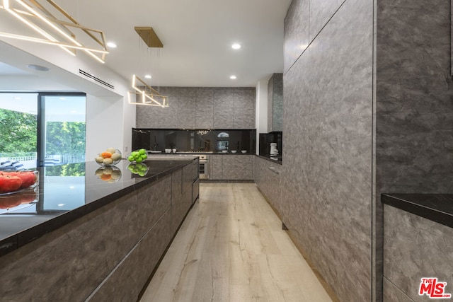 kitchen with pendant lighting and light hardwood / wood-style flooring