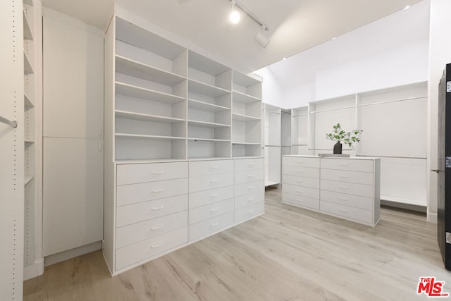 spacious closet with light hardwood / wood-style floors