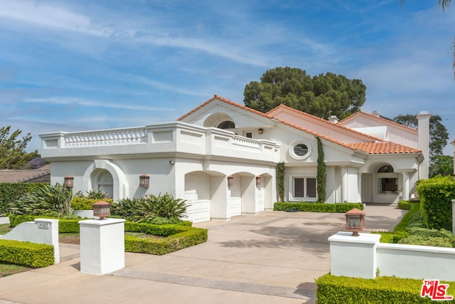 mediterranean / spanish-style home featuring a garage