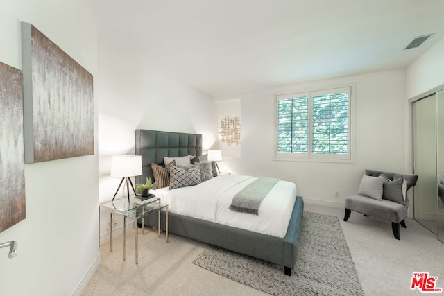 bedroom with light colored carpet