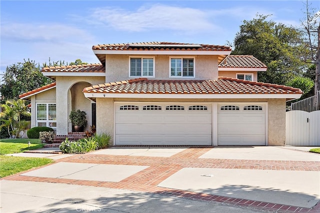 mediterranean / spanish-style house with a garage