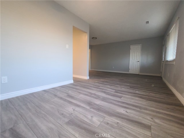 spare room with light hardwood / wood-style flooring