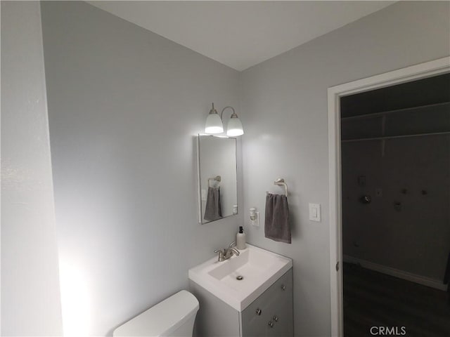 38633 Glenbush Ave, Palmdale, CA 93550 - bathroom with vanity, toilet, and wood finished floors