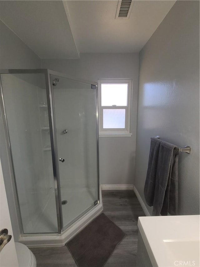 38633 Glenbush Ave, Palmdale, CA 93550 - full bath with a stall shower, toilet, wood finished floors, baseboards, and vanity