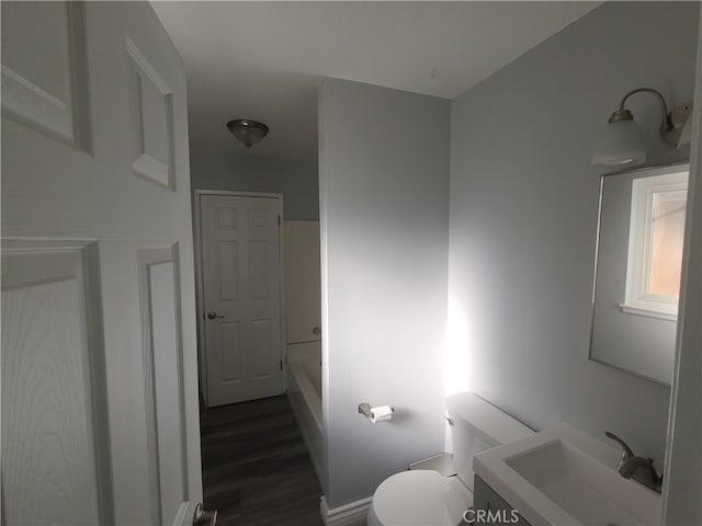 full bathroom with shower / bathtub combination, hardwood / wood-style flooring, vanity, and toilet