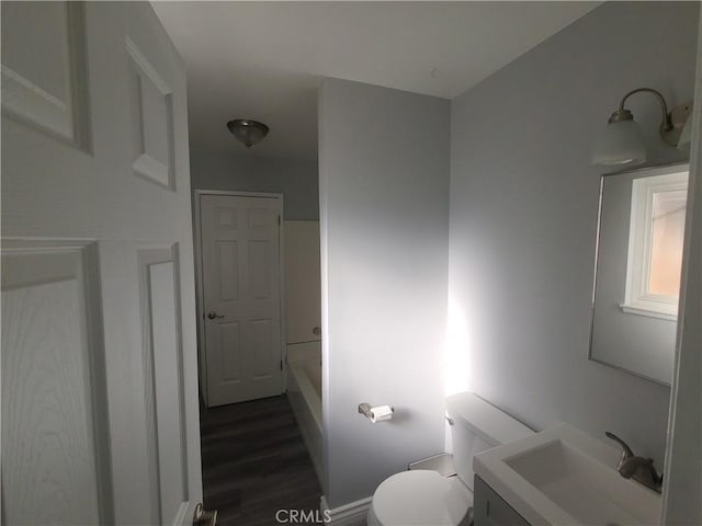 38633 Glenbush Ave, Palmdale, CA 93550 - full bathroom with vanity, toilet, wood finished floors, and baseboards