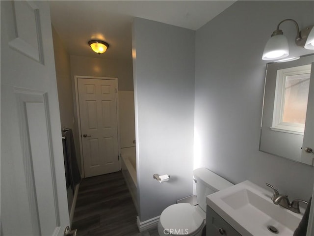 38633 Glenbush Ave, Palmdale, CA 93550 - bathroom with vanity, toilet, wood finished floors, and baseboards