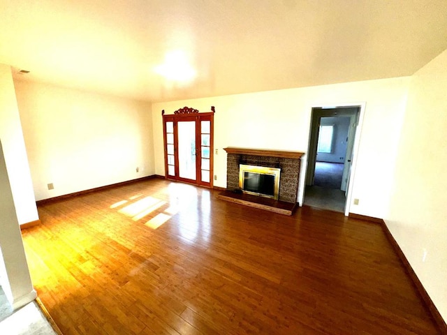 unfurnished living room with hardwood / wood-style floors and a fireplace