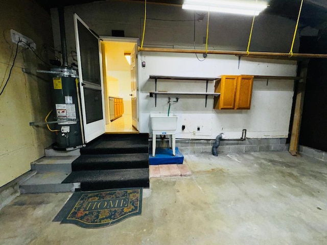 basement featuring water heater and sink