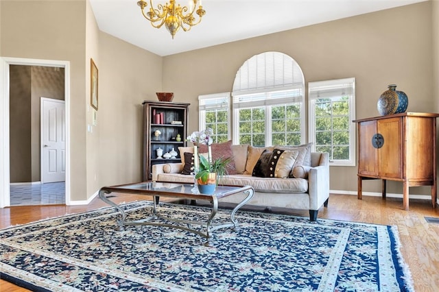 living room with an inviting chandelier and light hardwood / wood-style floors