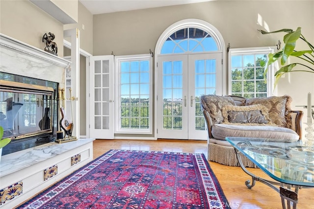 sunroom with a fireplace and french doors