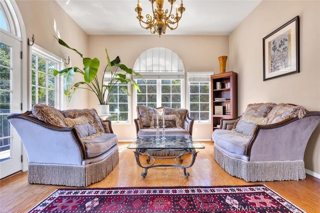 living room with an inviting chandelier and wood-type flooring