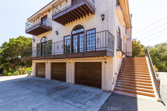 exterior space with a balcony and a garage