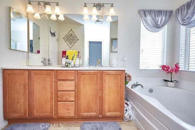 bathroom featuring vanity, tile patterned flooring, and a washtub