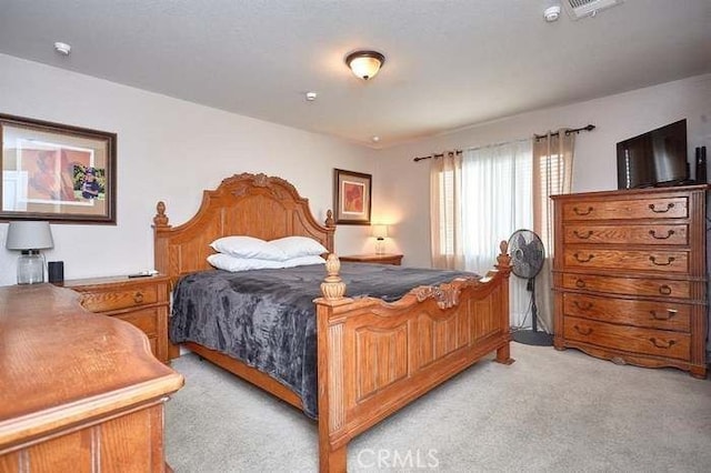 bedroom featuring light colored carpet