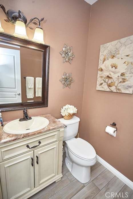 bathroom featuring hardwood / wood-style floors, vanity, and toilet