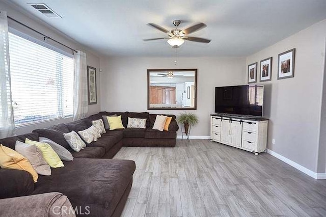 living room featuring light wood-type flooring and ceiling fan