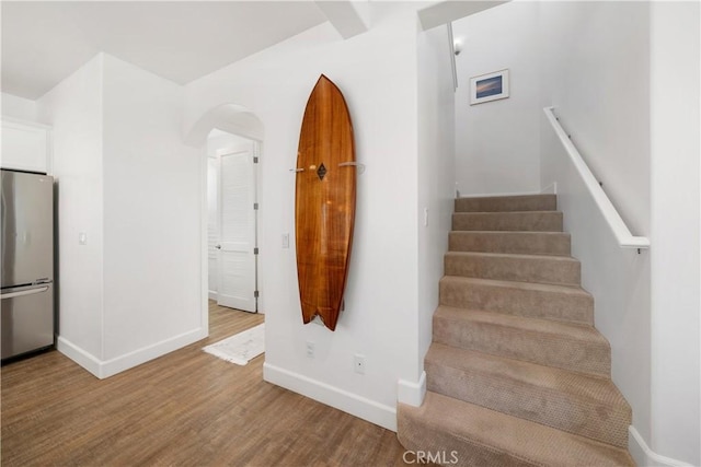 stairway with hardwood / wood-style flooring