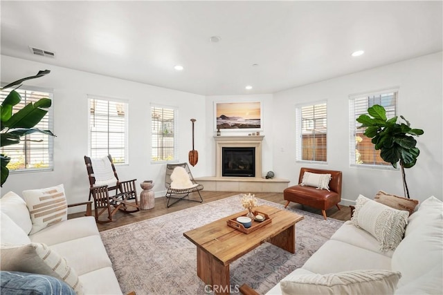 living room featuring light hardwood / wood-style flooring and a tile fireplace