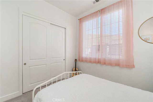 carpeted bedroom with a closet