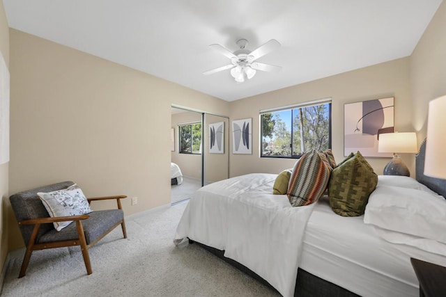 bedroom with a closet, light colored carpet, and ceiling fan