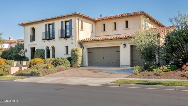 mediterranean / spanish home featuring a garage