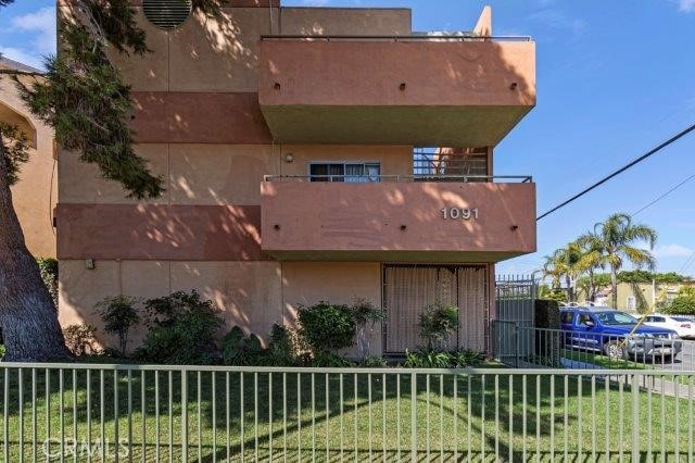 exterior space with a lawn and a balcony