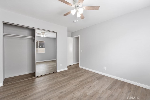 unfurnished bedroom with a closet, light hardwood / wood-style floors, and ceiling fan