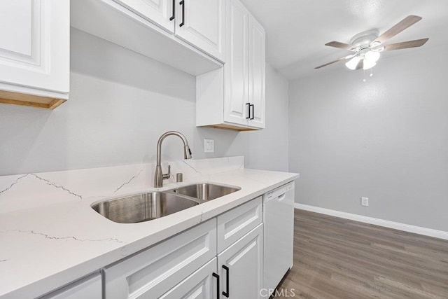 kitchen with dark hardwood / wood-style flooring, white cabinets, white dishwasher, and sink