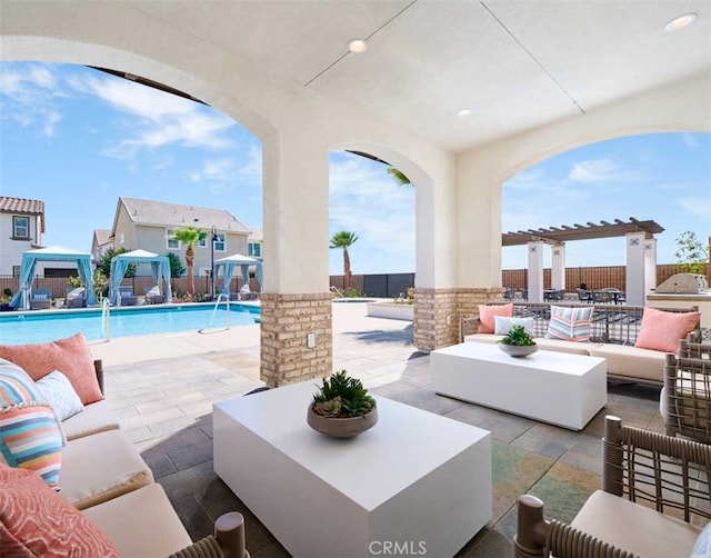 view of patio / terrace with a community pool, a gazebo, an outdoor living space, and a pergola