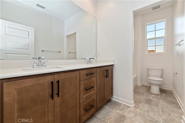 bathroom featuring toilet and vanity