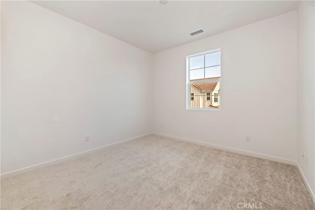 unfurnished room with light carpet