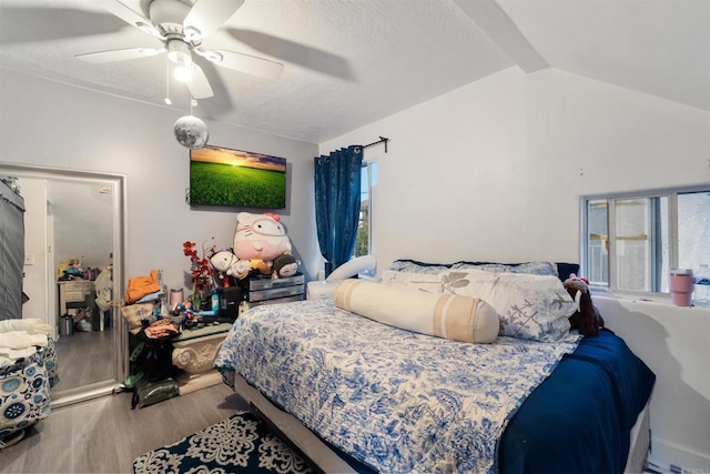 bedroom featuring multiple windows, lofted ceiling, light wood-type flooring, and ceiling fan