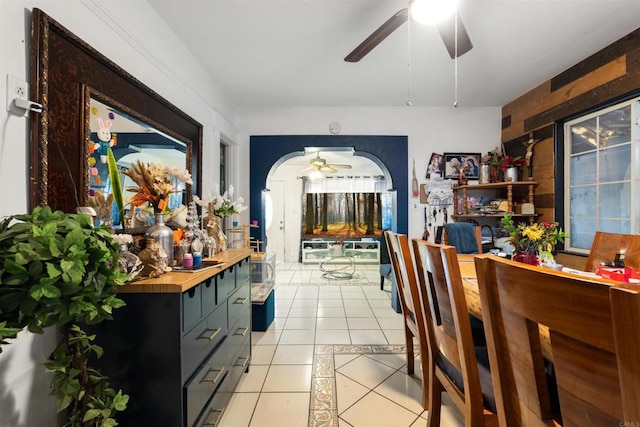 tiled dining space with ceiling fan