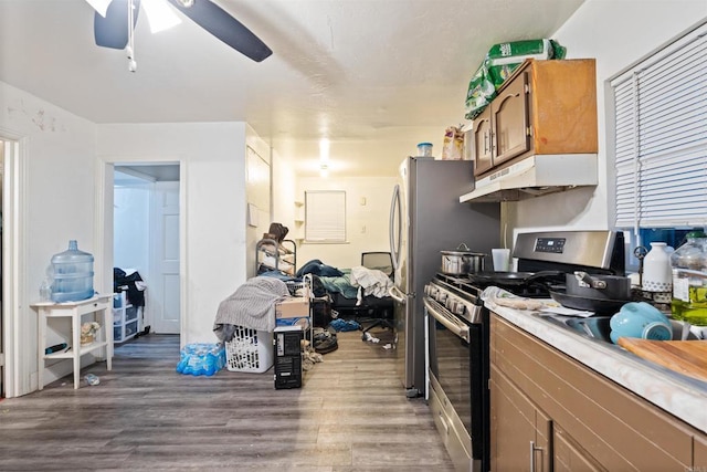 3838 Van Dyke Ave, San Diego, CA 92105 - kitchen featuring stainless steel range with gas stovetop, under cabinet range hood, wood finished floors, a ceiling fan, and light countertops