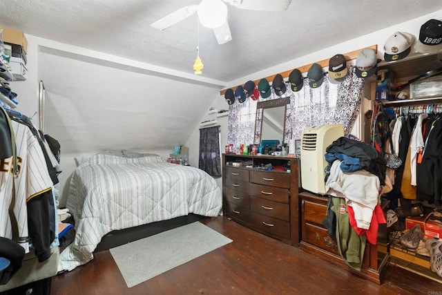 bedroom with ceiling fan, a closet, dark hardwood / wood-style floors, and vaulted ceiling