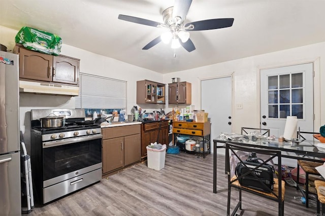 3838 Van Dyke Ave, San Diego, CA 92105 - kitchen featuring stainless steel appliances, under cabinet range hood, ceiling fan, and light wood-style floors