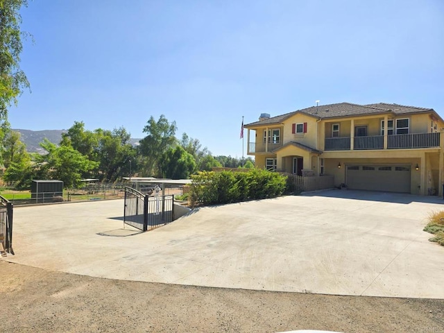 view of front of house with a garage, concrete driveway, and stucco siding