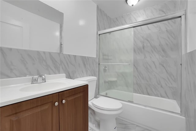 full bathroom featuring toilet, tasteful backsplash, combined bath / shower with glass door, tile walls, and vanity