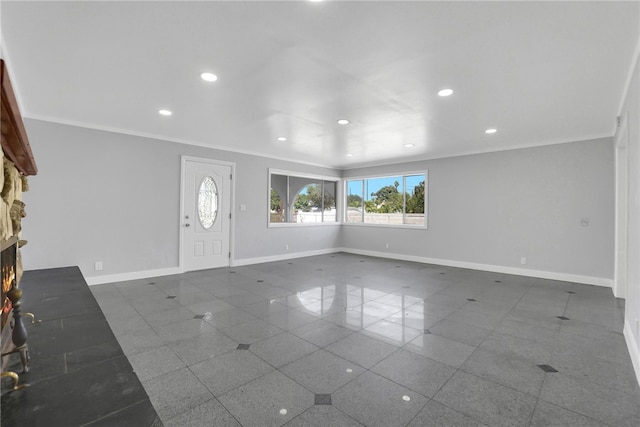 entrance foyer featuring ornamental molding and a stone fireplace