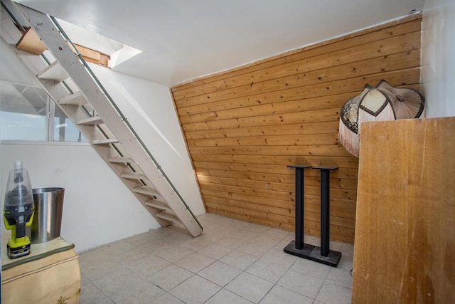 interior space with wooden walls and tile patterned floors