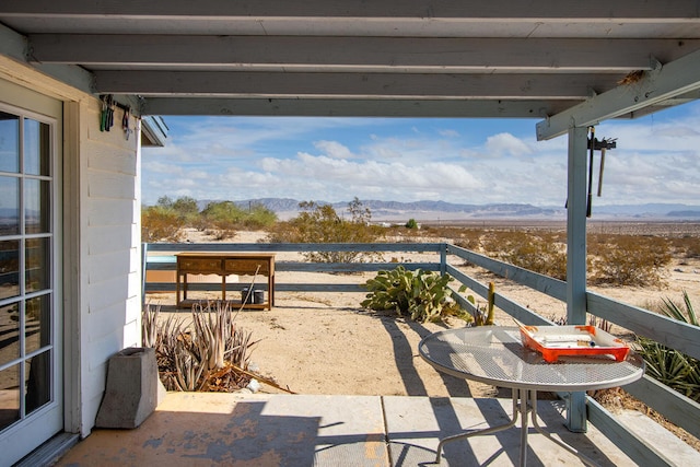 view of patio / terrace featuring a mountain view