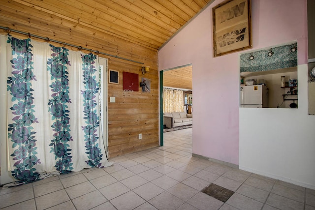 tiled empty room with wood ceiling, wood walls, and high vaulted ceiling