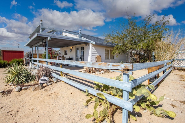 rear view of property with a shed