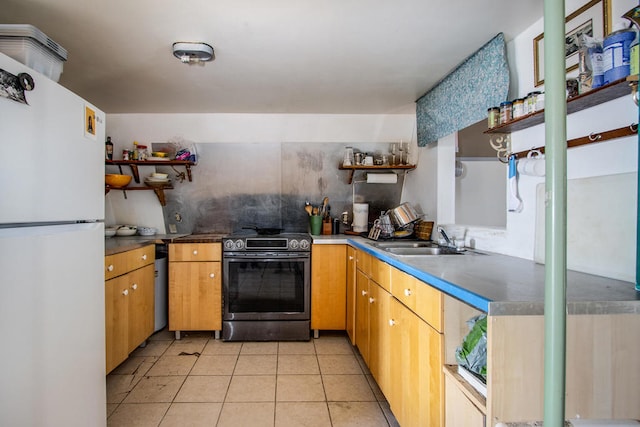 kitchen with stainless steel range with electric cooktop, light tile patterned floors, white fridge, and sink